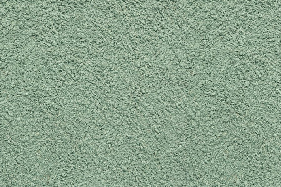 Freshly hydroseeded ground with green-dyed mulch on a Southwest Louisiana job site